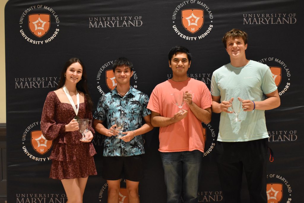 Sarah Davis (standing in for Sanaya Moore), Noah Oppelt, Ishan Joshi, and Chase Baldwin present their House Spirit Awards