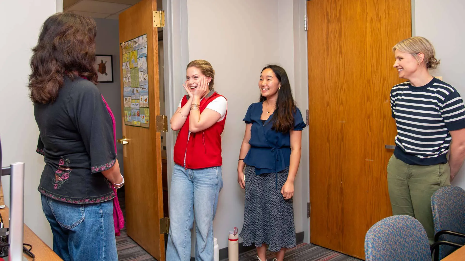 From left, Leslie Brice Bustamante, assistant director of the National Scholarships Office, informs Vivian Maneval ’27 and Michelle Wang ’27 of their Udall Scholarships, while Angela Mazur-Gray, assistant director of the Environmental Science and Policy Program, looks on. (Photo by Laura Barnhardt Cech)